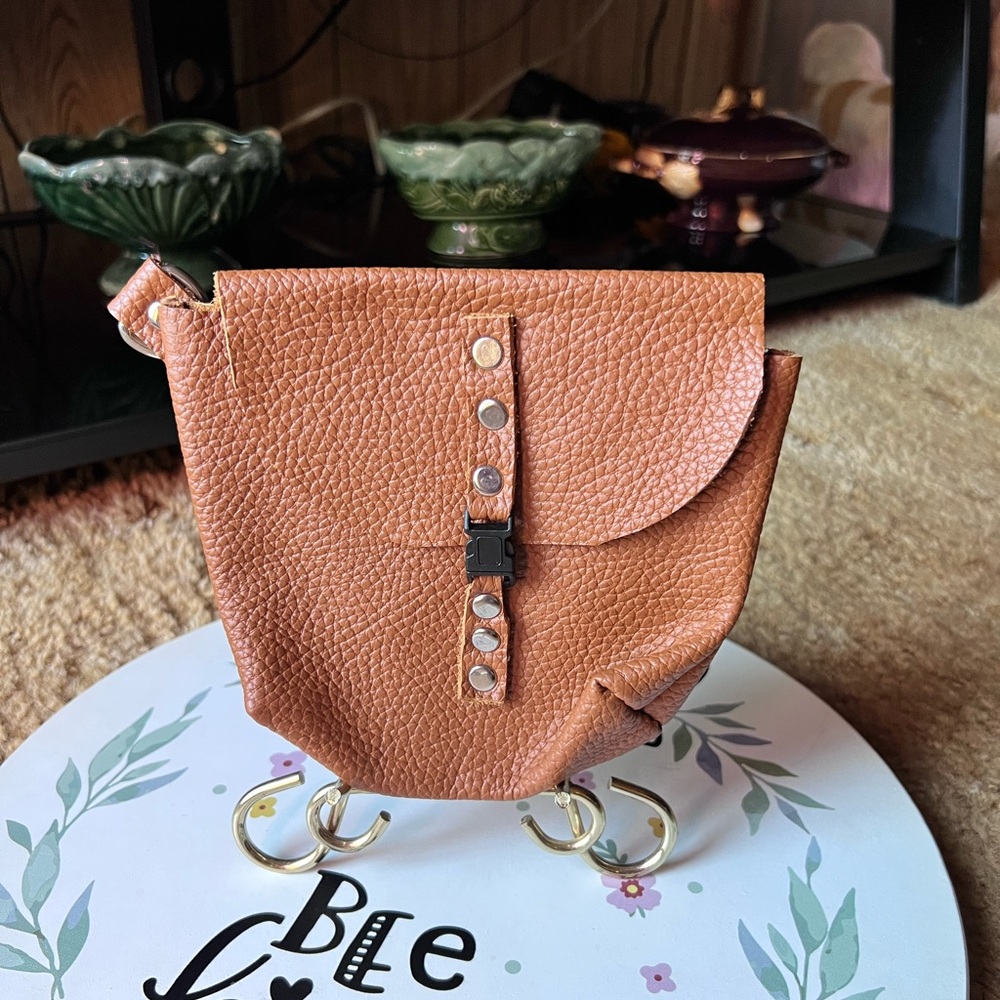 Genuine leather handmade pouch with metal loop for adding to belt.